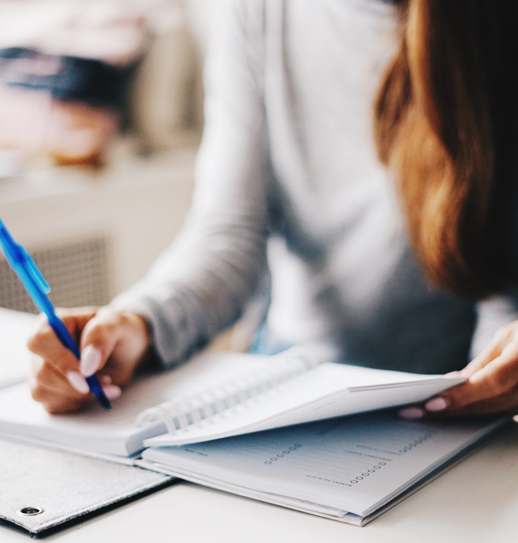 Woman writing in a notepad