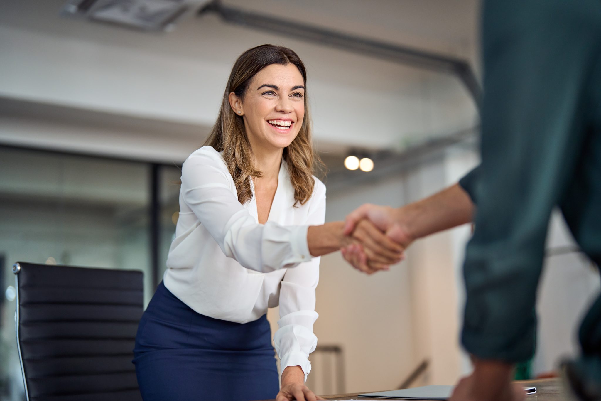 business woman greeting client in office.