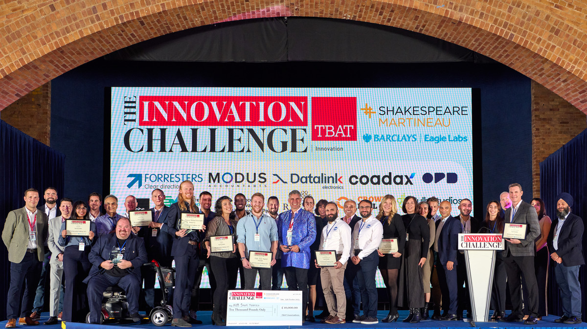 The Innovation Challenge Finalists all standing on a stage at the Finalist Showcase