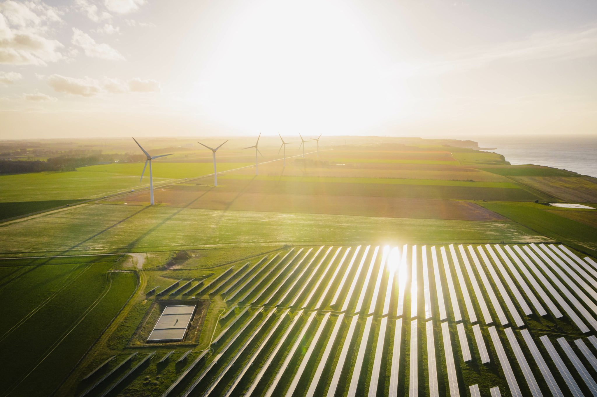 Wind turbines and solar panels farm in a field. Renewable energy